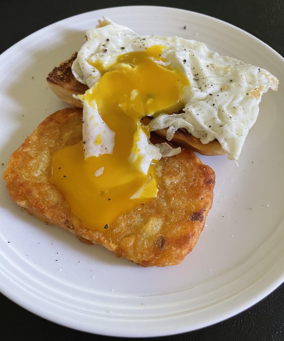 Ooey gooey egg over Hawaiian roll and hash brown