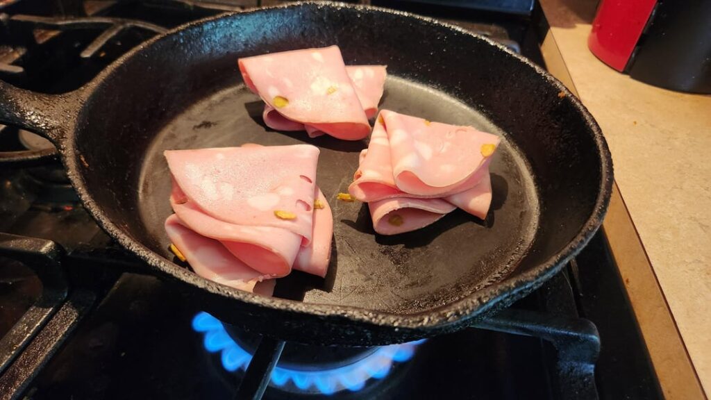 Anthony bourdains fried mortadella and provolone sandwich with mustard and mayonnaise