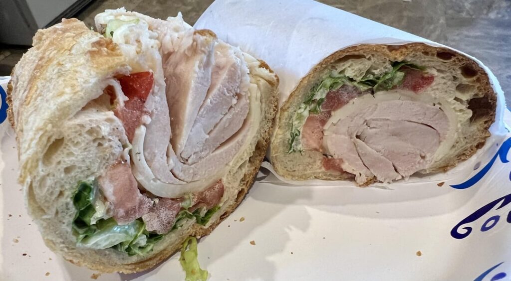Thiccc turkey on homemade baguette with lettuce, tomato, provolone, and mayo.