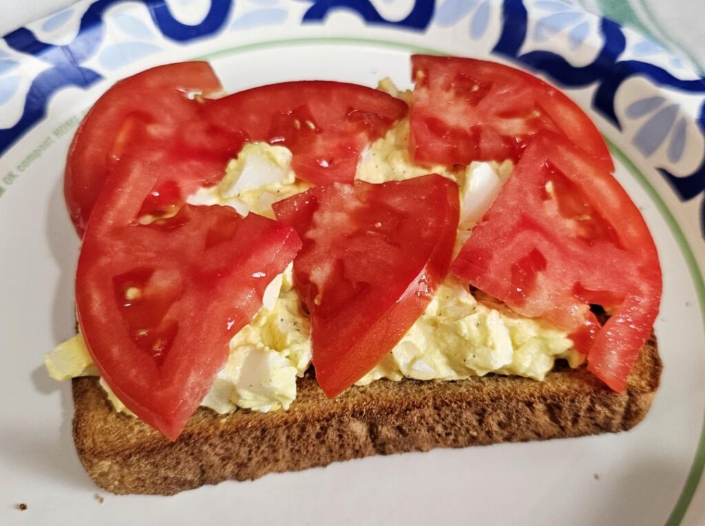 Open faced egg salad and tomato on whole wheat