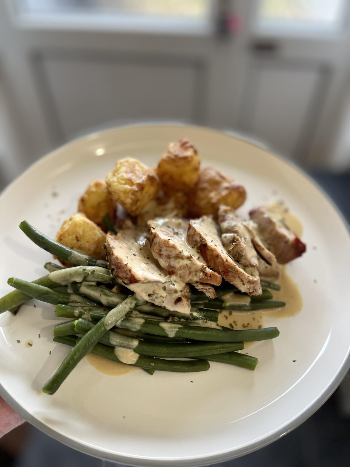 Pork loin, Dijon mustard and crème fraiche sauce, roast spuds and green beans.