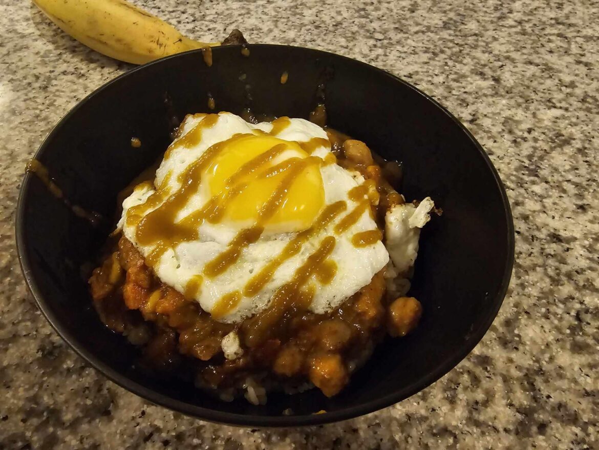 Inspired by /u/MightNotApply!  Jasmine rice, chickpea Chana Masala (in a bag).  I didn't add tikka masala spices but did put siracha and an egg.  - Accidental banana for scale?