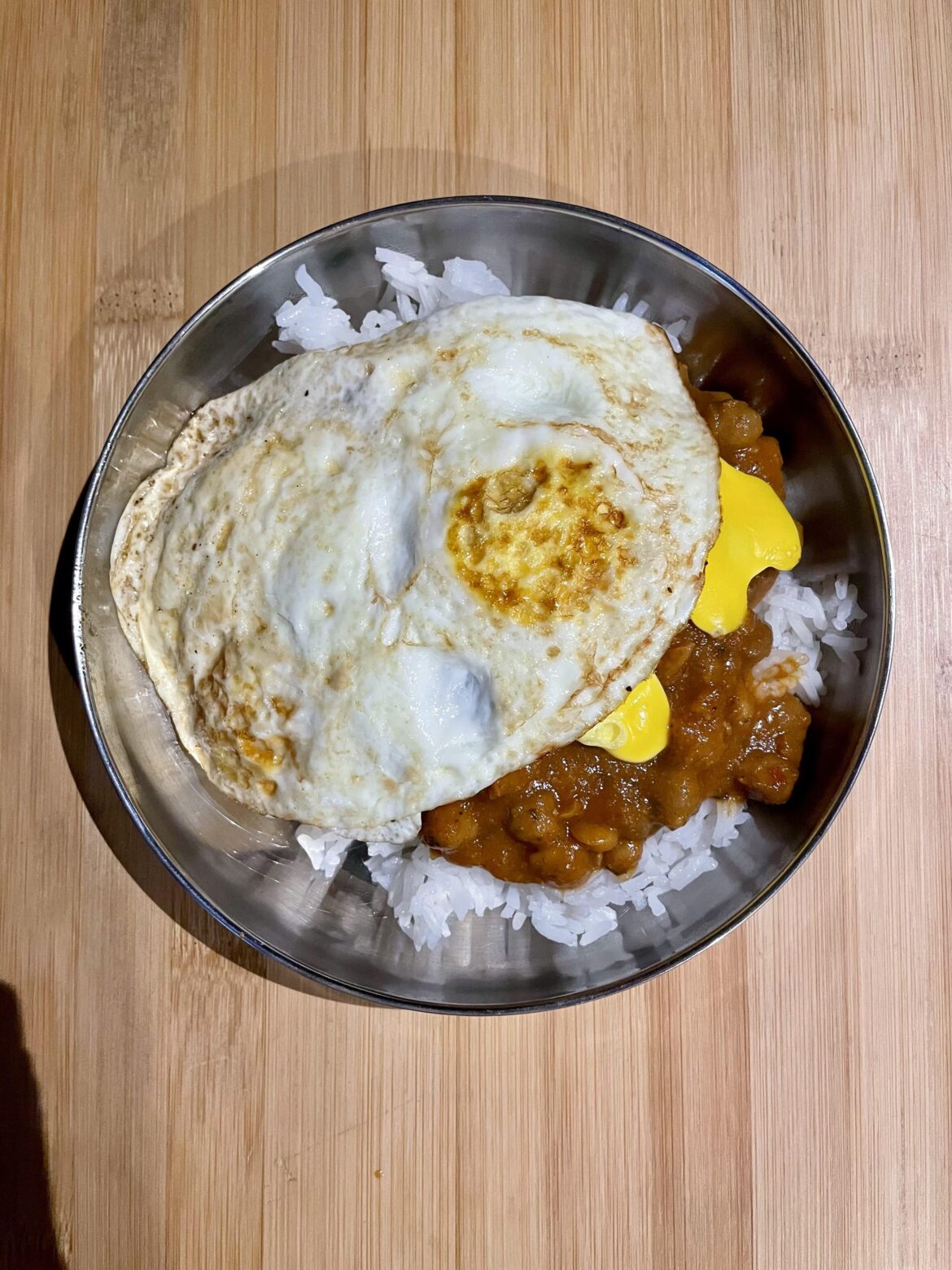 On rice & lentils, and I broke a yolk on the flip