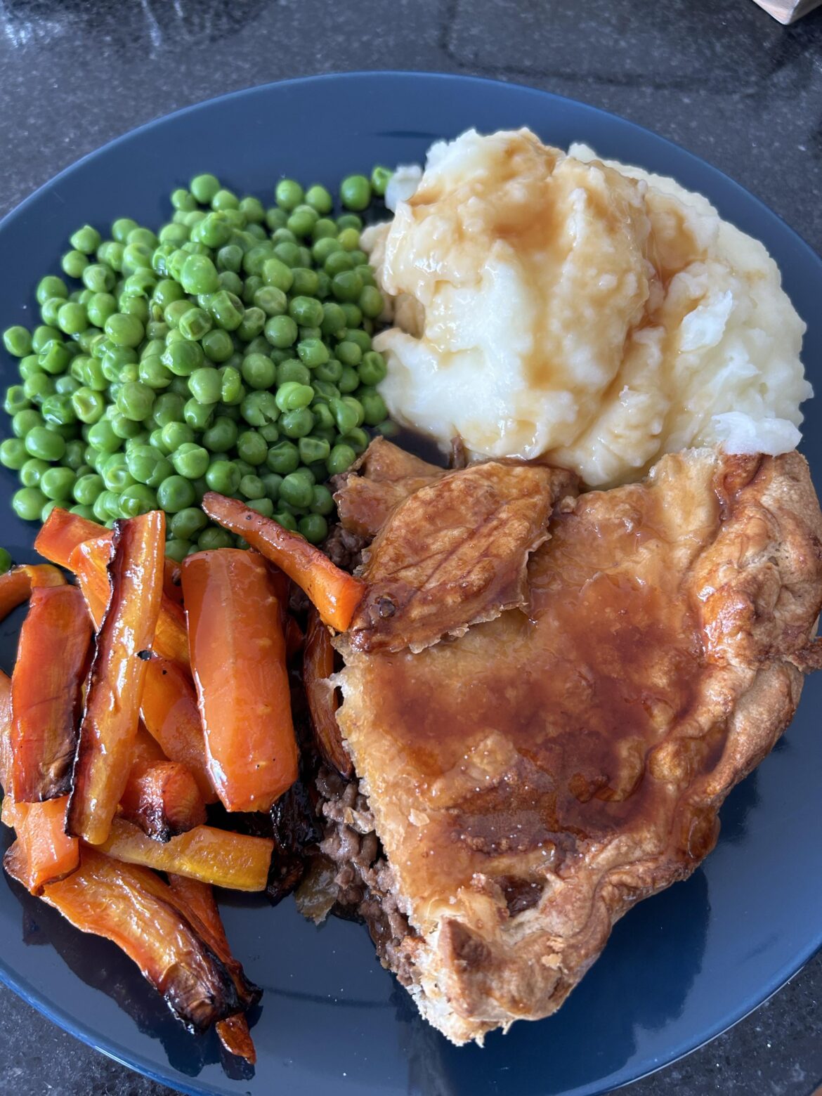 Pie and mash with roasted carrots and peas