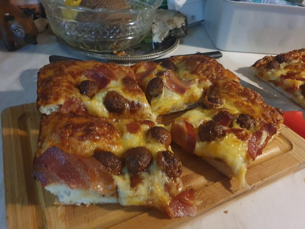 Domino-ts pizza with spicy meatballs, bacon, spicy pepperoni and bbq sauce.