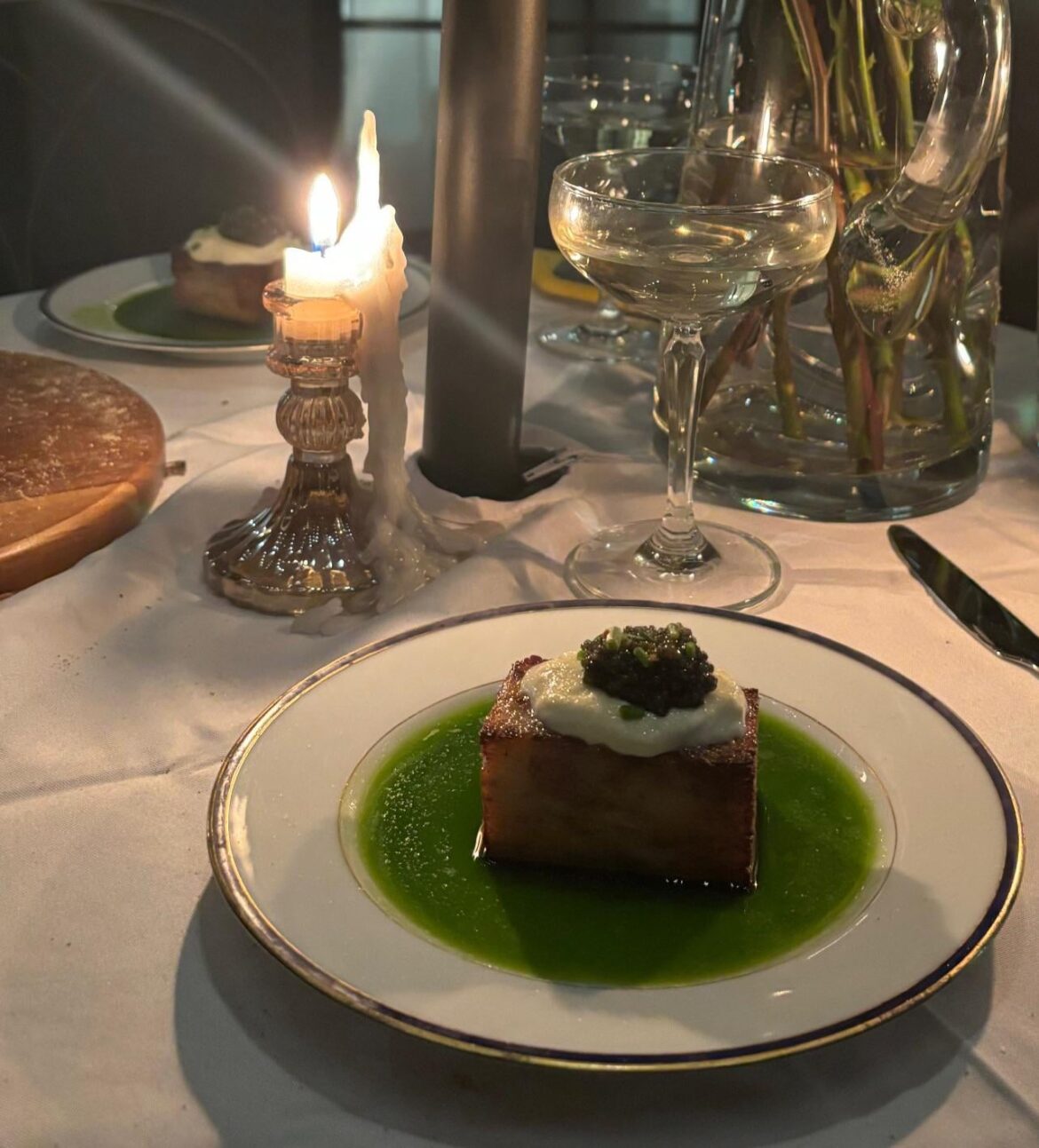 Potato Pavé with parsley oil, crème fraîche, caviar, and citric salt