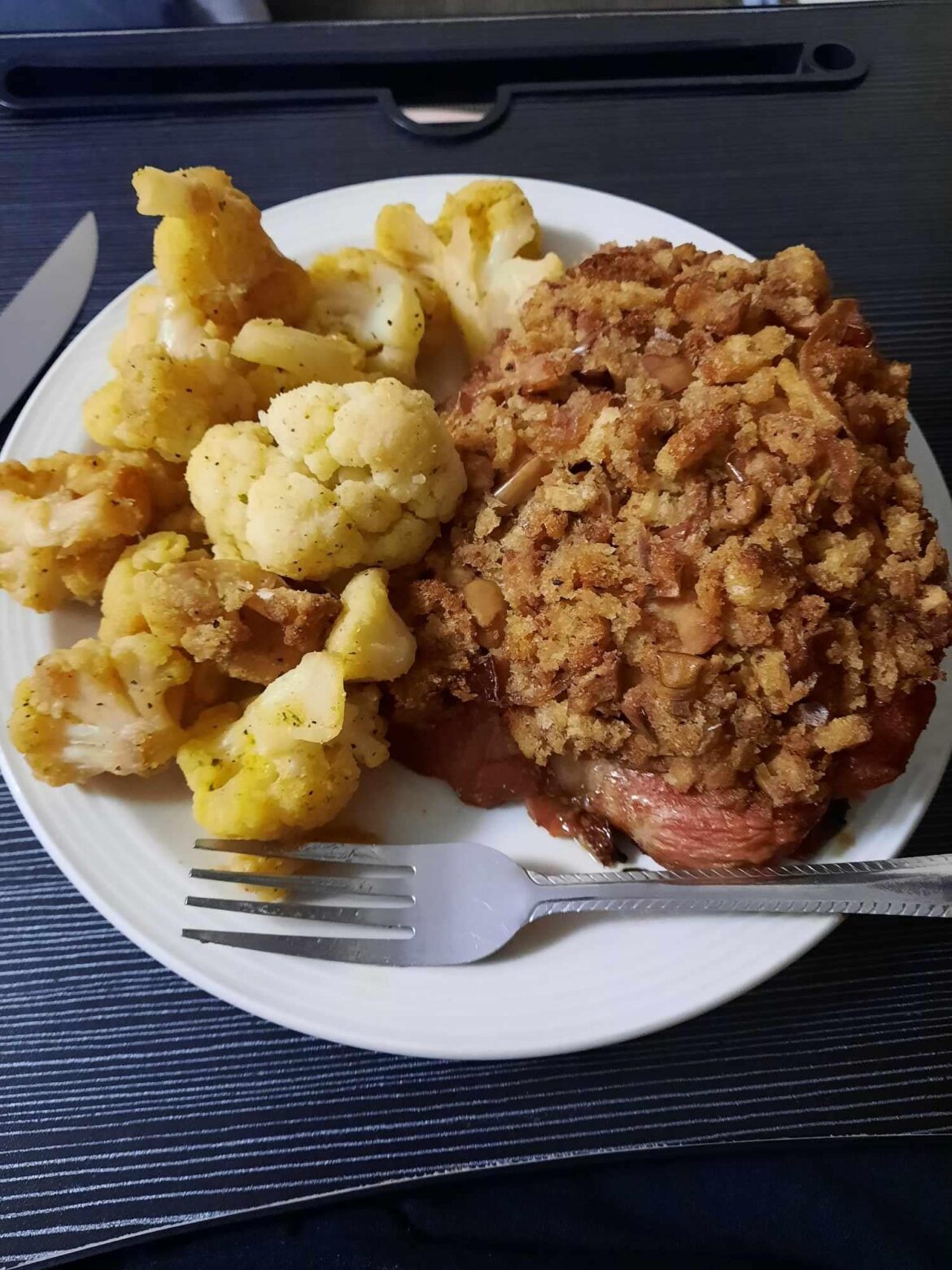 Smoked LemonPepper cauliflower with Smoked Iowa chops topped with maple, apple and plum dressing.