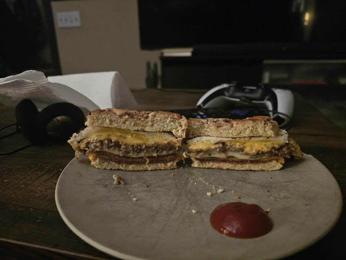 Goetta, Pork Roll, Bacon, Egg, and American and Pepper Jack Cheese on an onion roll