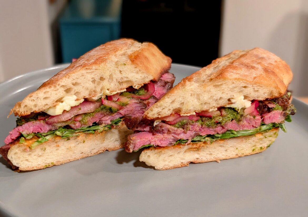 Ribeye (137F, 2 hours, pan sear), smoked bleu cheese, chimichurri, chipotle mayo, pickled onions and arugula on ciabatta baguette