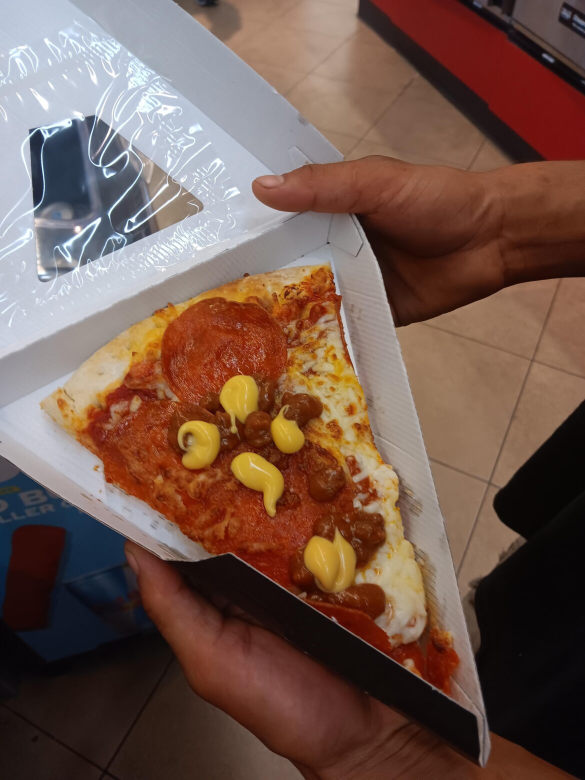 My coworkers lunch. Gas station pizza with chili and cheese