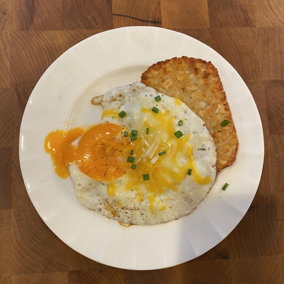 Tasty golden Happy Egg yolk on hashbrowns