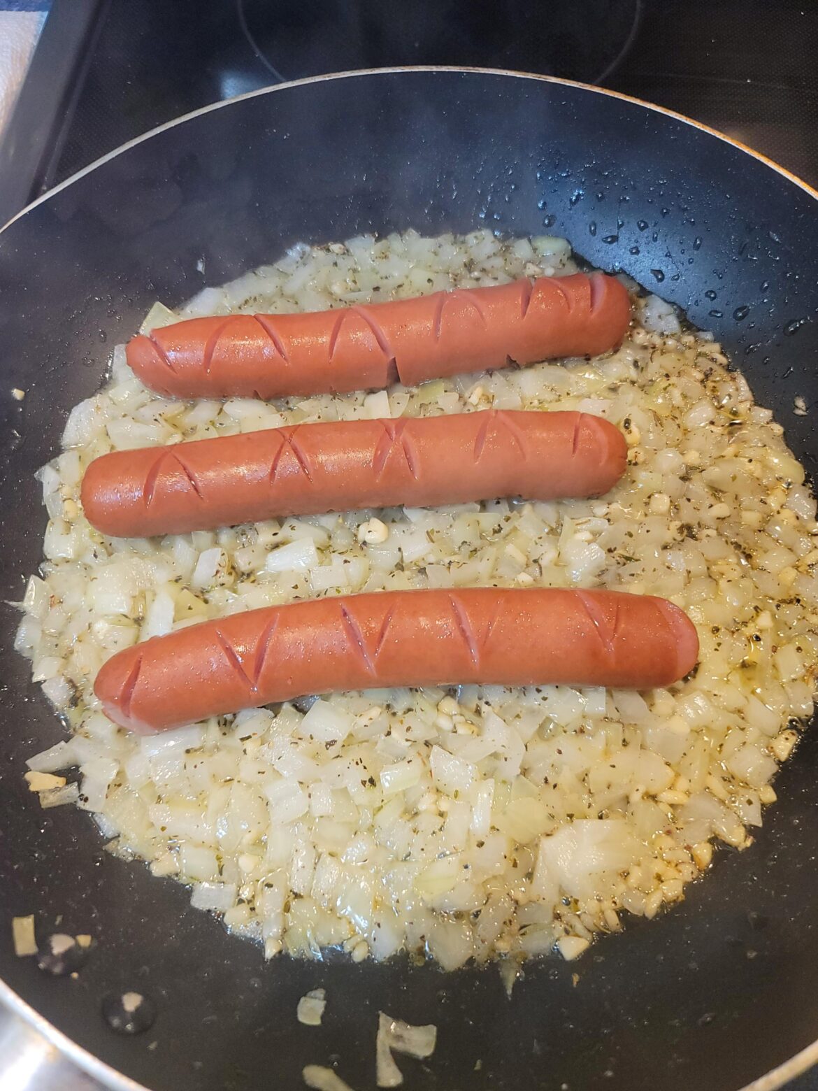 I always cook my dogs over a bed of onions, cover them and let them steam. Then you have sautéed onions below, onion essence in the dog and raw onions on top