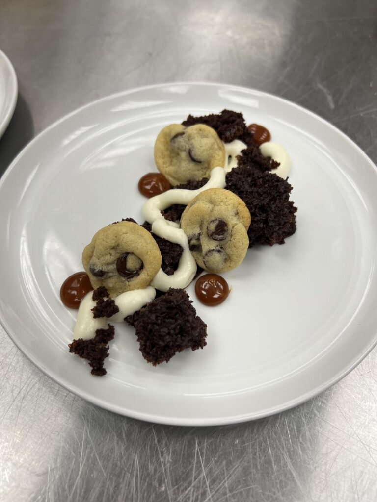 Chocolate cake with white chocolate mousse, mini chocolate chip cookies, coffee ganache and salted caramel sauce.