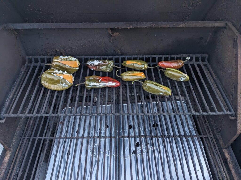 The pepper saga continues. Smoked poblanos and jalapeños, stuffed with cream cheese, cheddar, and Monterey jack.