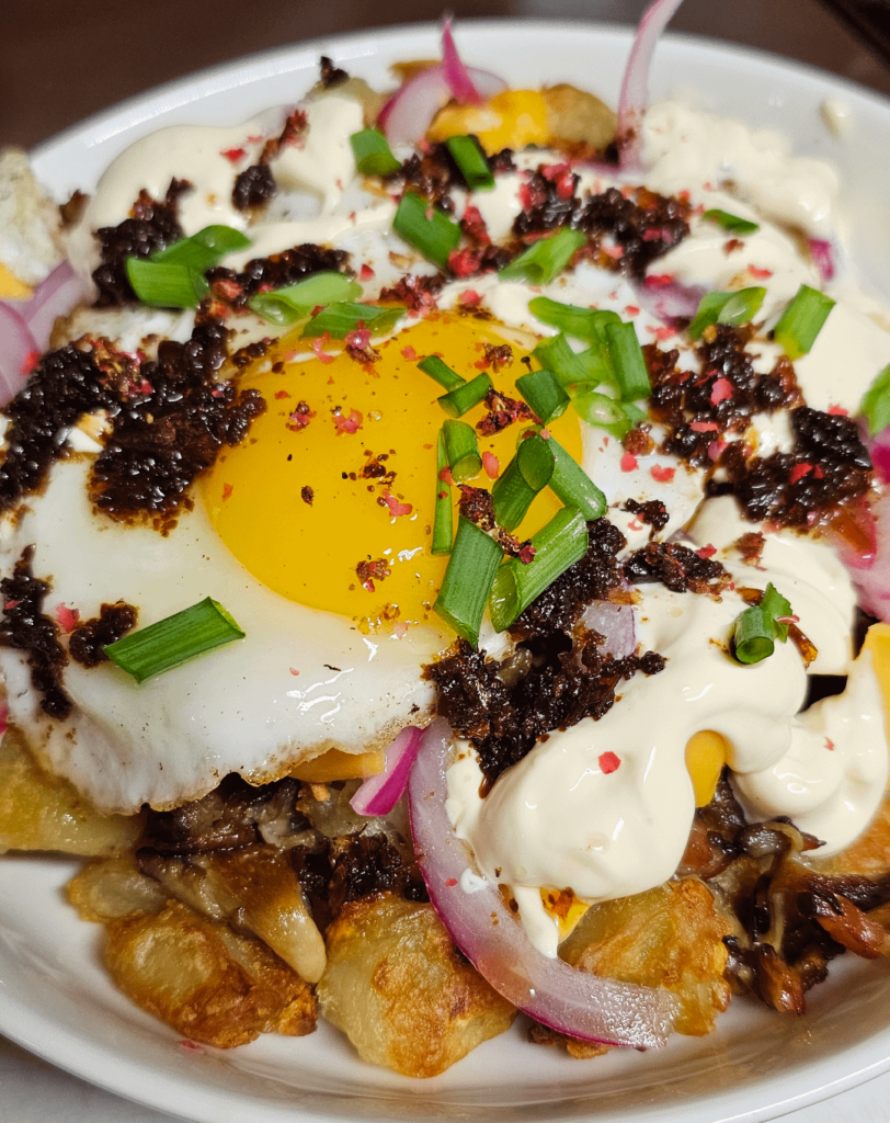 Fully loaded garlic roasted taters with bacon, sauteed mushrooms, and an egg.