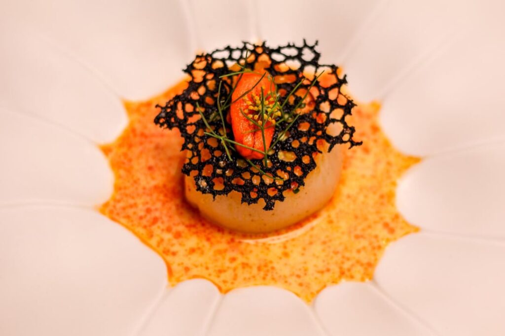 Seated scallop, uni burre blanc, paprika oil