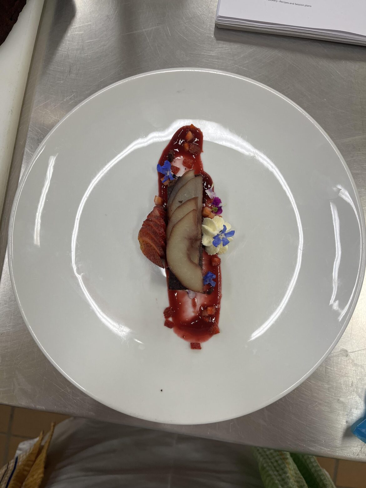 Flourless chocolate hazelnut cake, red wine poached pear, raspberry coulis