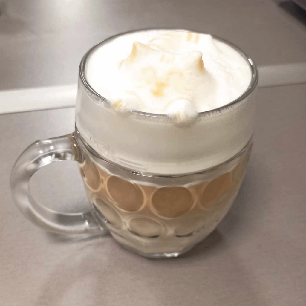 Practicing 3D latté art on my colleague's coffee, which contains 8 espresso shots