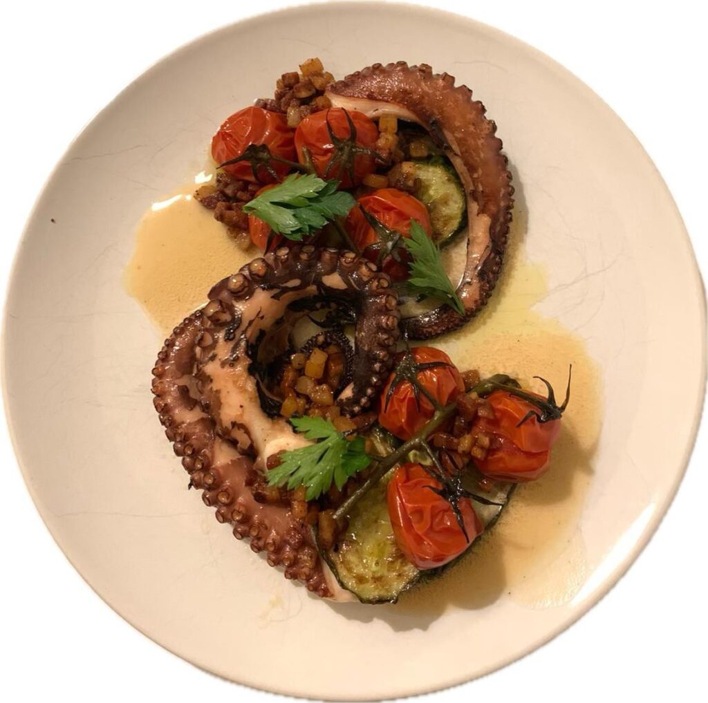 Octopus with grilled cucumbers, confit tomatoes, and guanciale vinaigrette.