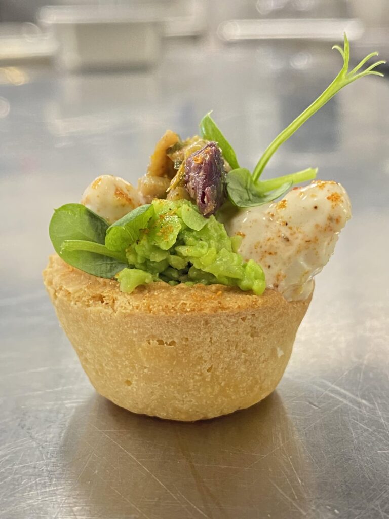 Crab Tartlet Amuse Bouche. “Joe’s” Meyer Lemon Mustard Sauce, Old Bay, Spring peas, Italian Heirloom Olive Tapenade