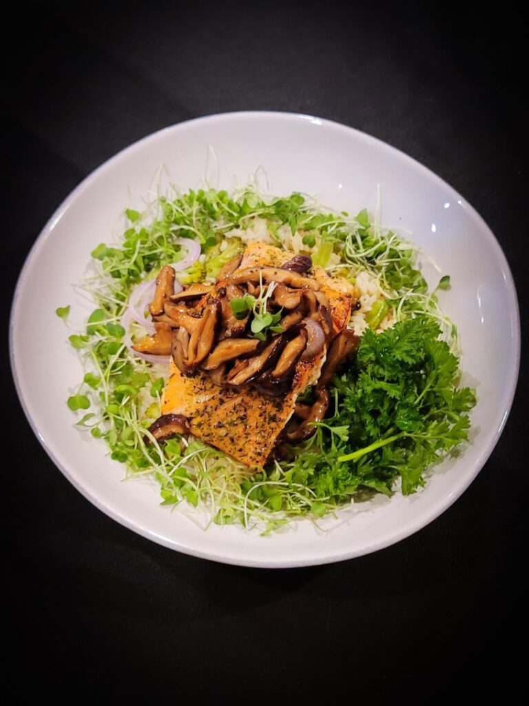 Pan-Seared Salmon +Brandy Glazed Mushrooms on a bed of rice broccoli and micro greens
