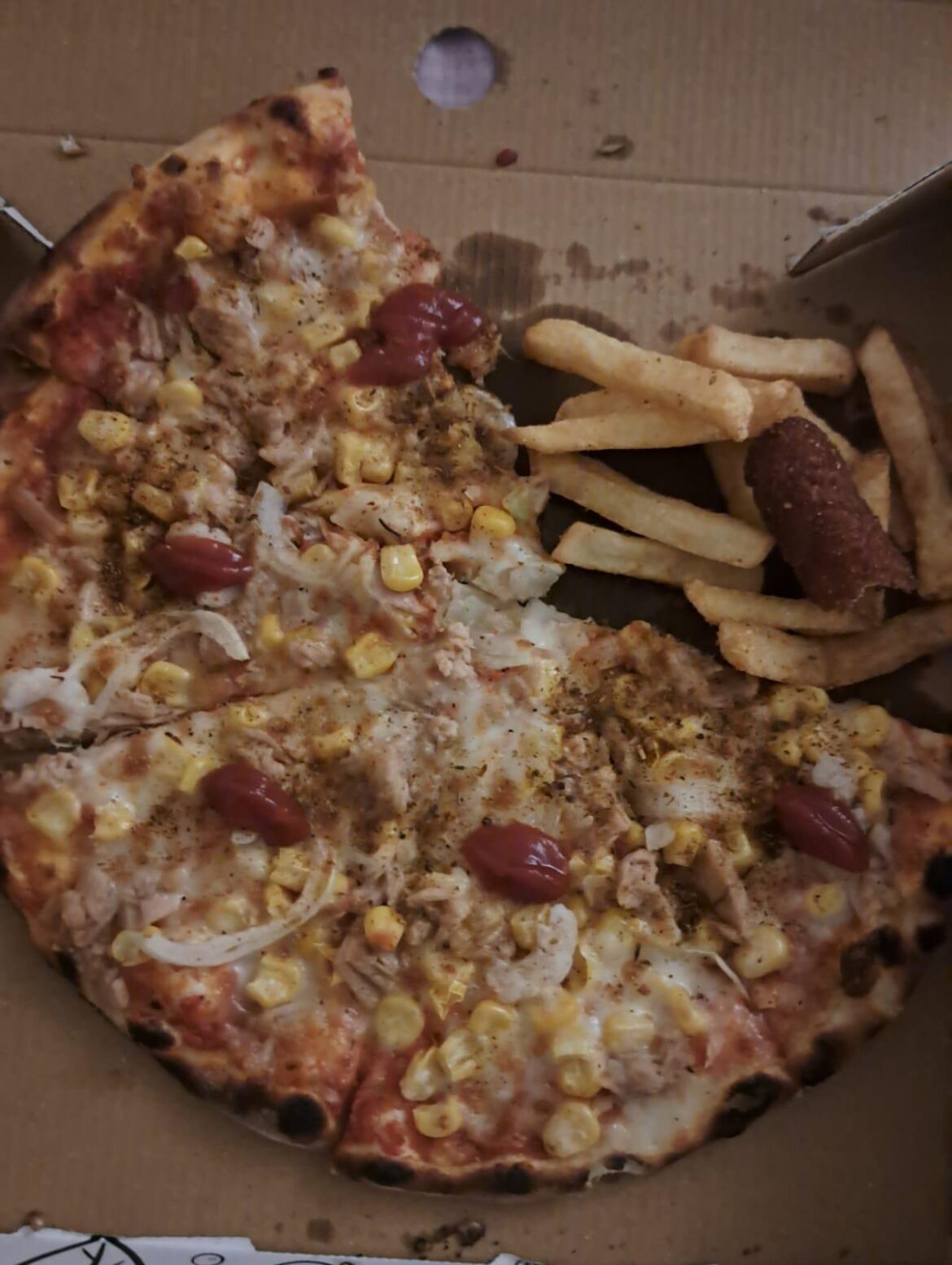 Girlfriends pizza with shrimp, canned tuna, ketchup, corn and onion