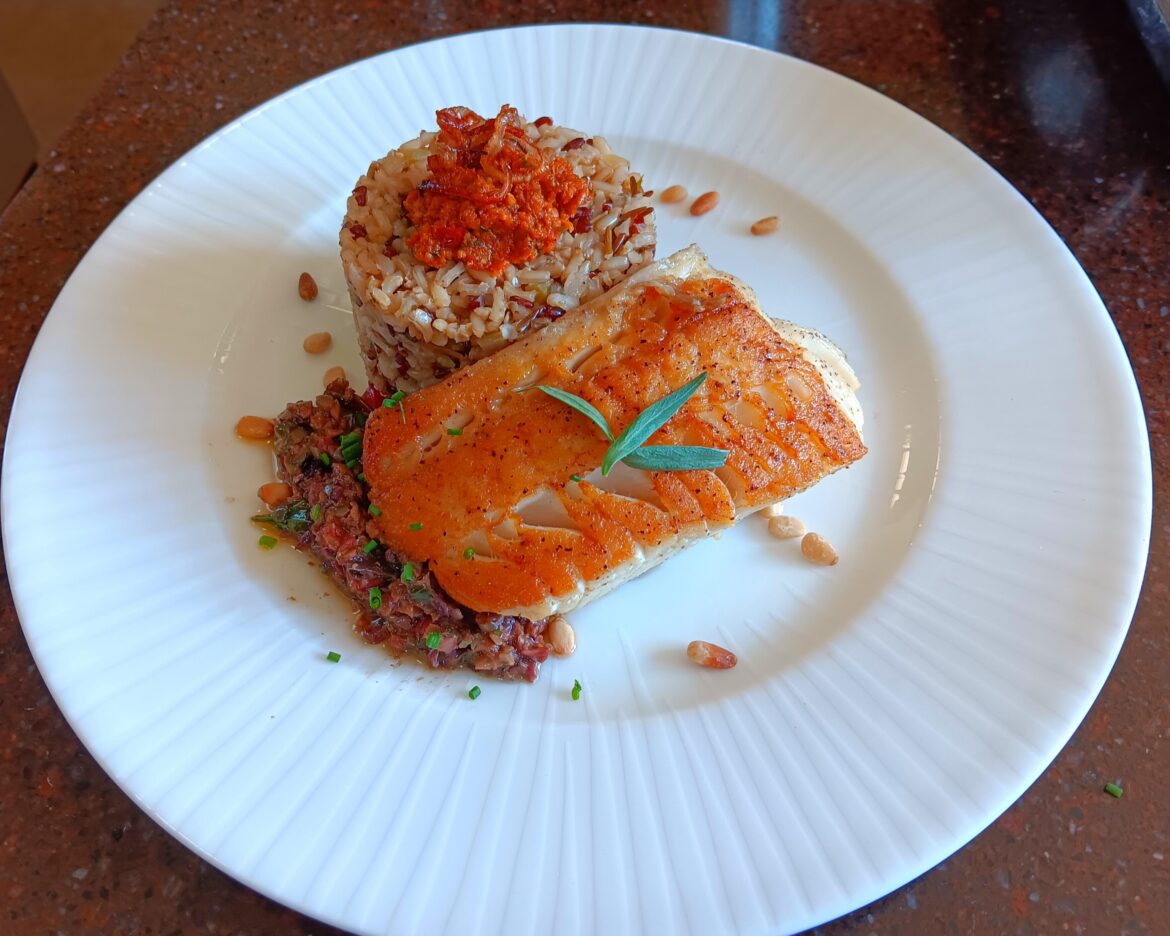 Seared Sable fish and wild mushroom tapanade with wild rice and sun-dried tomato pesto and crispy shallots and roasted pine nuts