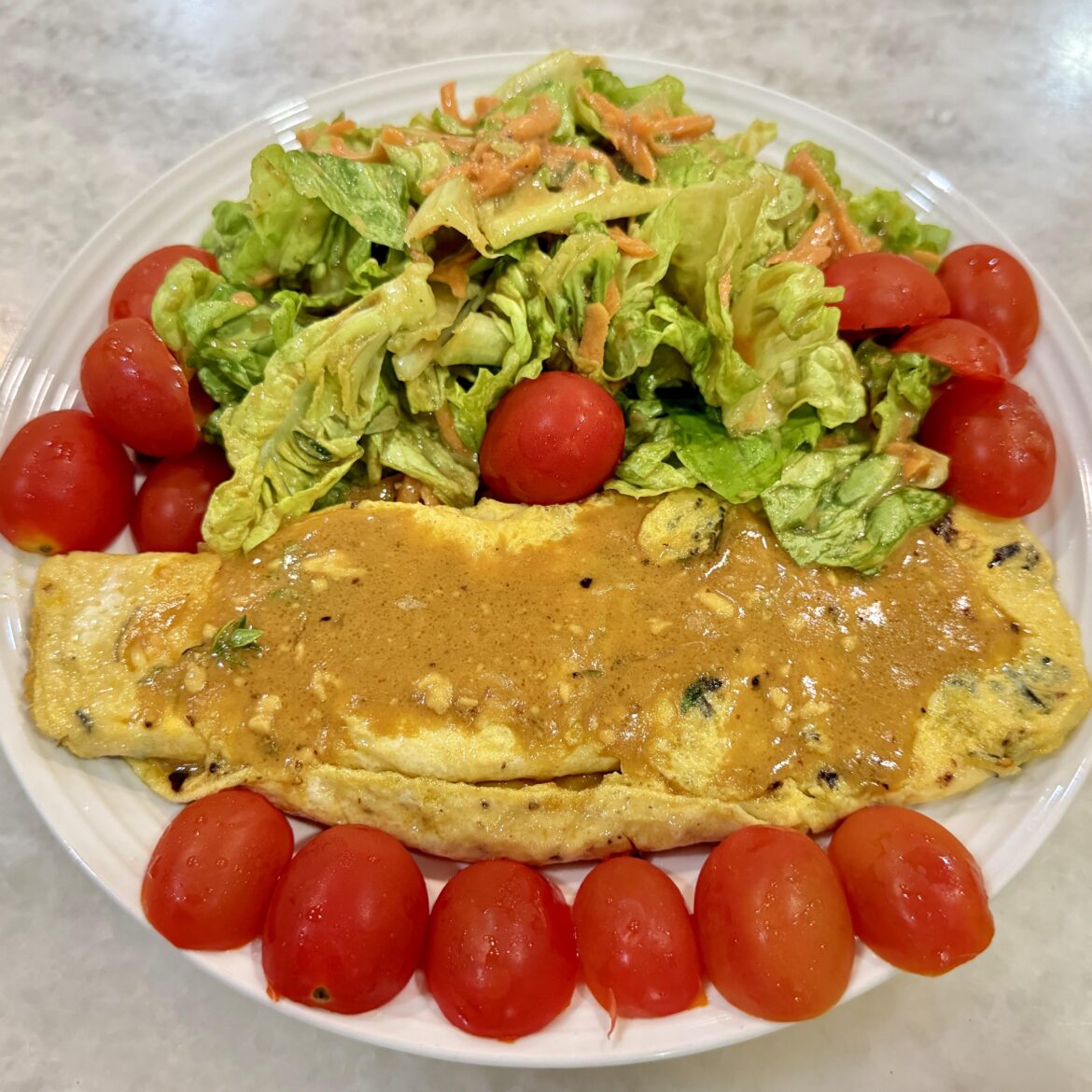 Eating alone for lunch. Simple Keto Dish, Omelette and Salad