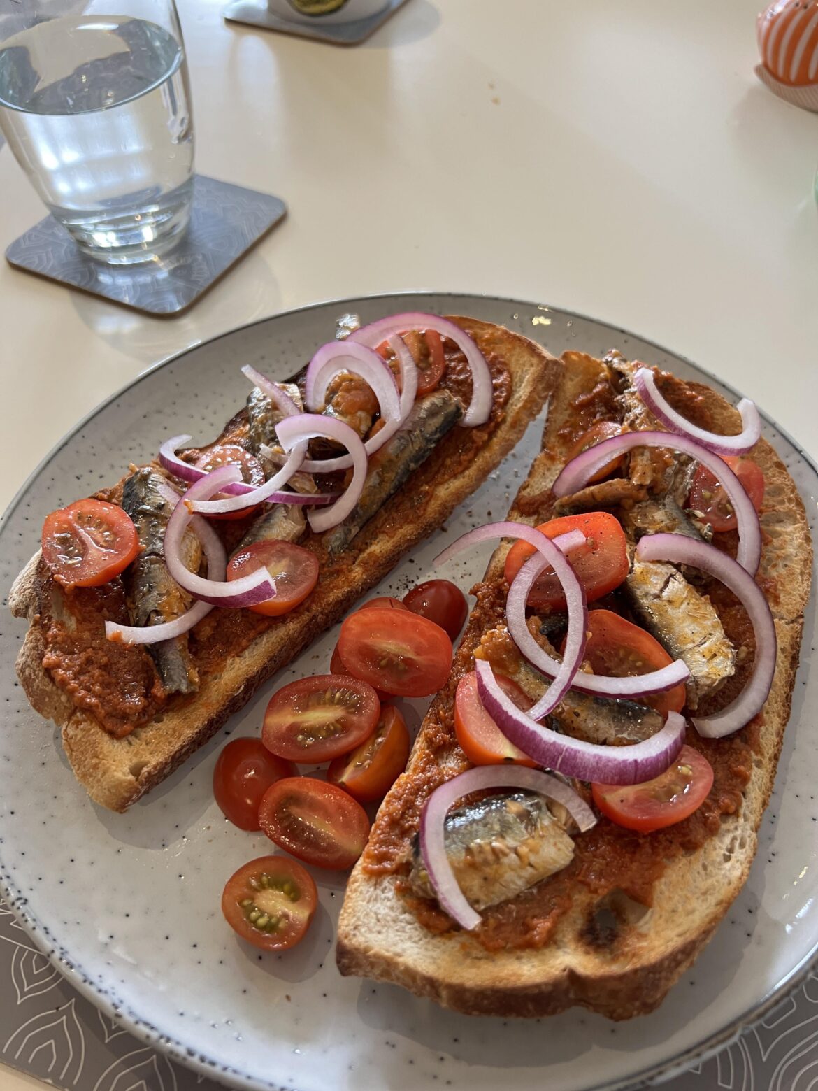 Lunch! Sardines, tomatoes, red onion and red pesto on sourdough toast
