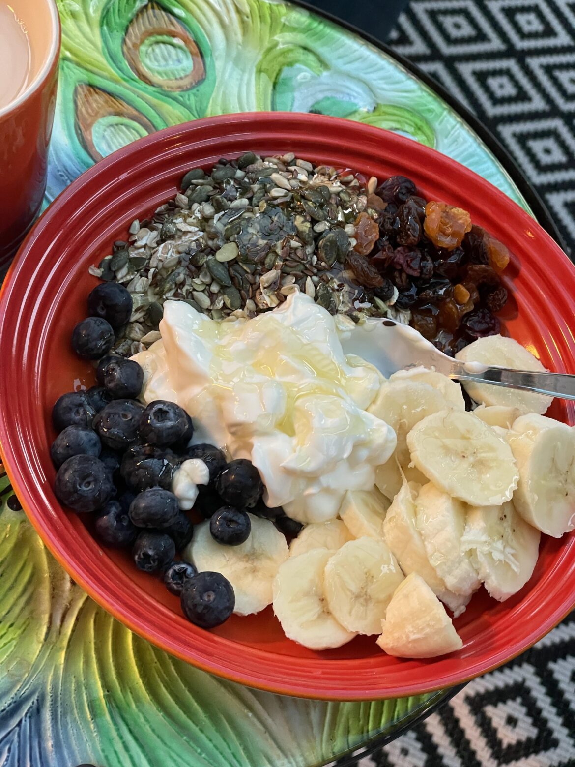 [Homemade] Muesli, mixed seeds, mixed dried fruit, banana, blueberries,  yogurt and local honey. With a cuppa.