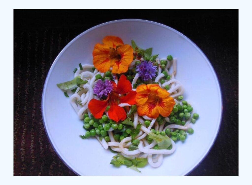 Delicious nasturtium flowers offer a delightful way to enhance a dishs elegance. Many of them have a hint of peppery zest. They look stunning in salads. The purple varieties are known as chive flowers.