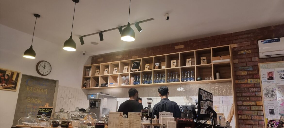 the tiny black board on the top shelf says "want to hear a joke? decaf."