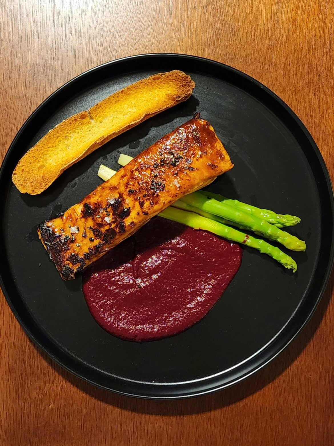 Salmon with hoisin glaze, beetroot purée, blanched asparagus and ciabatta.