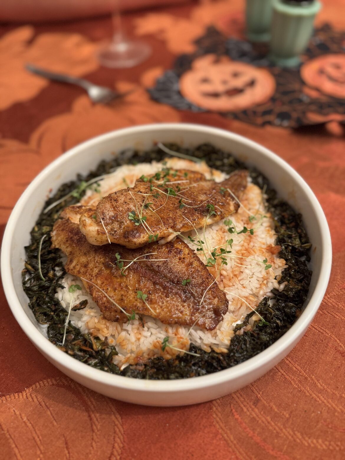 Blackened pan seared catfish,  jasmine rice, spicy collard greens, wasabi micro-greens, spicy fish reduction