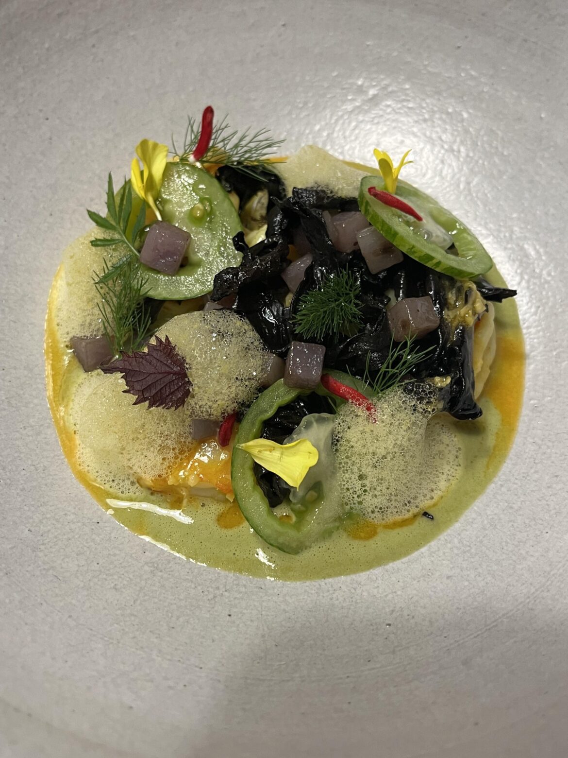 Montauck prawns, potato skin dashi broth, lemon verbena foam, black trumpets, and green tomato.
