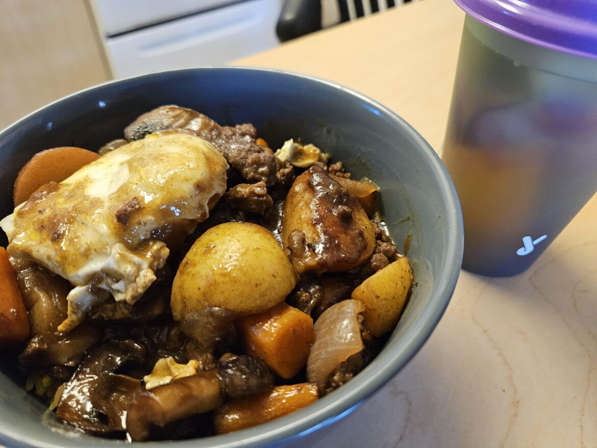 beef curry with veggies and an egg on rice