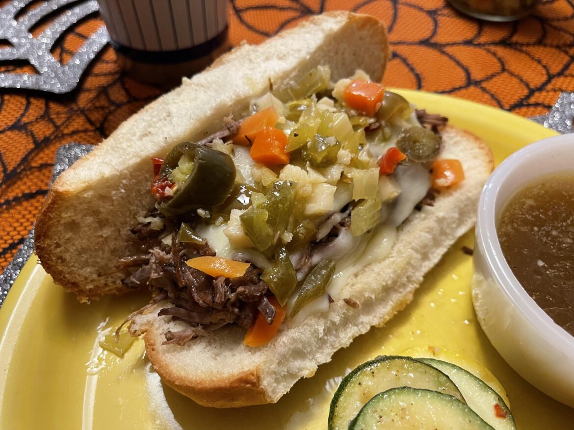Homemade shredded Italian beef with mozzarella, provolone, giardiniera, pepperoncini, and au jus