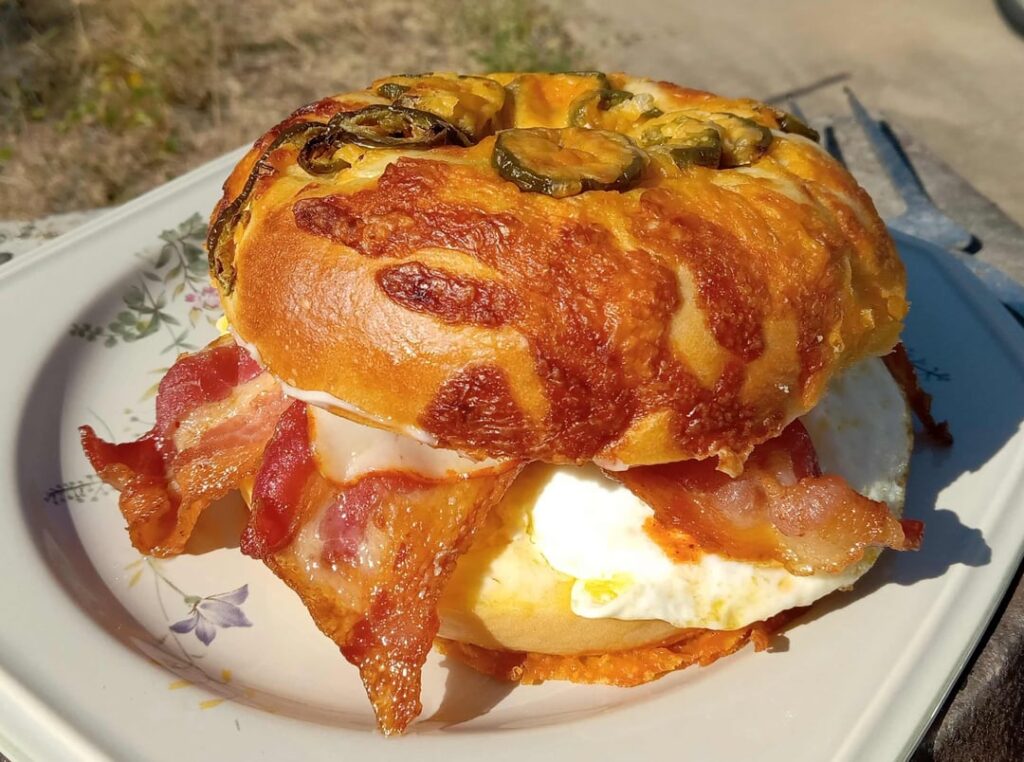 Brunch Bagel: 3 bacon, 2 eggs over medium, 1 muenster on a toasted and buttered jalapeno cheese bagel