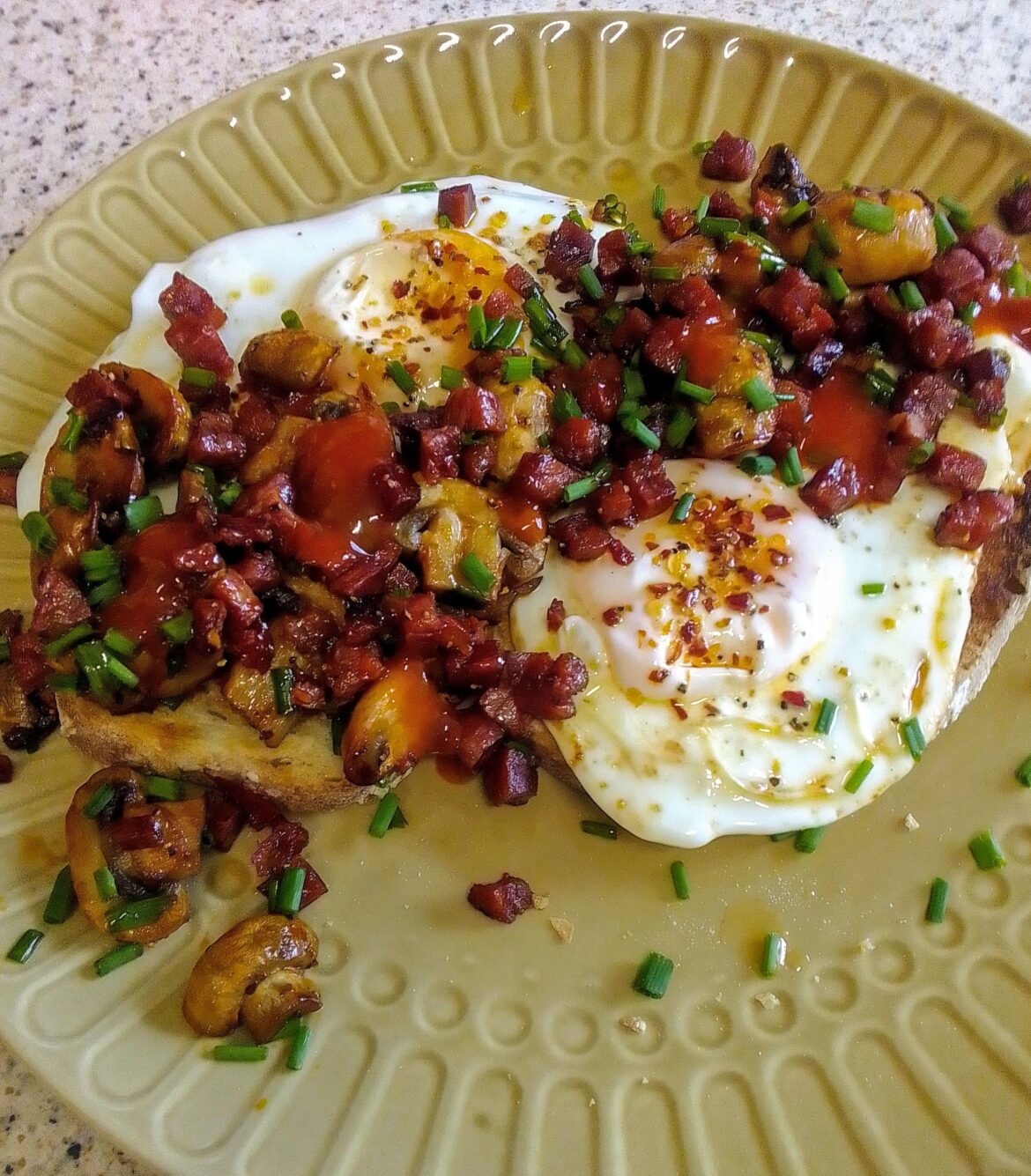 Brunch, eggs on toasted sourdough with mushrooms, chorizo and sriracha.