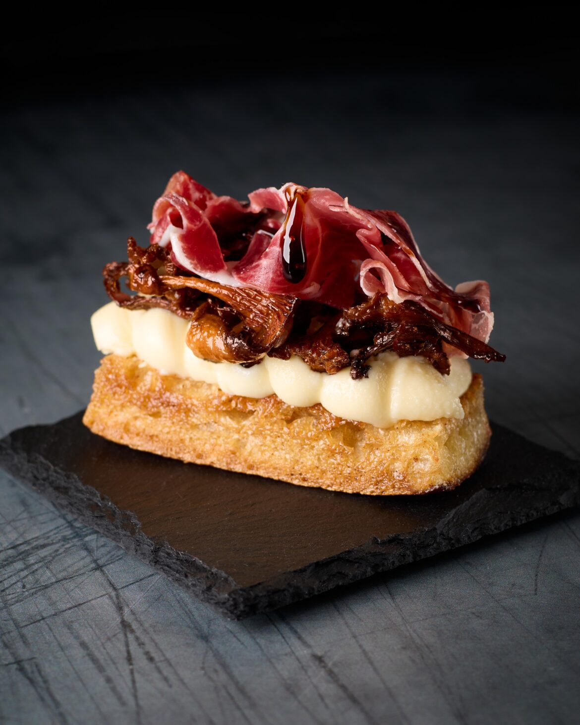 Sourdough bread, Västerbotten cheese, chanterelles, and Iberico. Topped with balsamic.