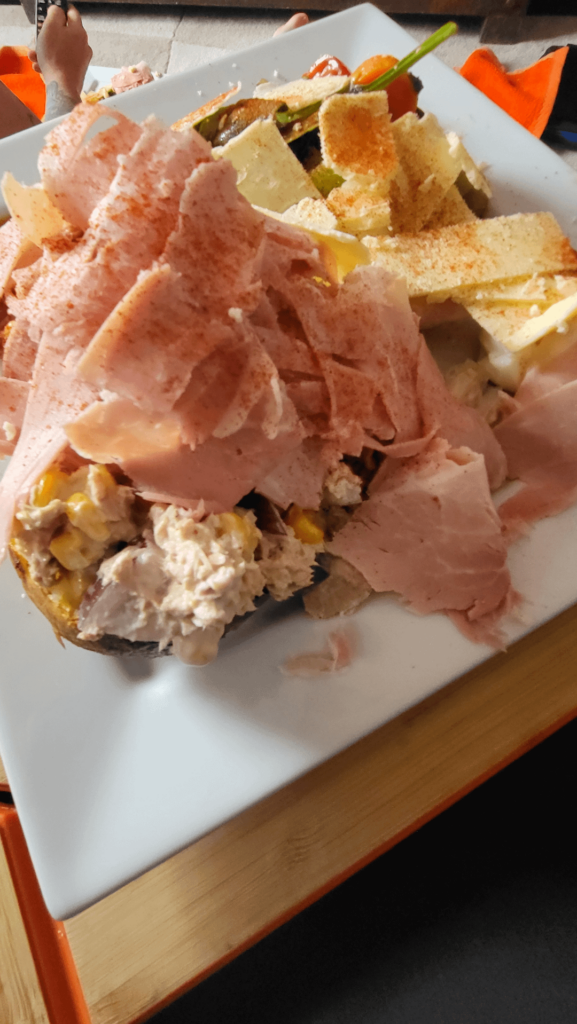 Jacket potato with tuna, onion, sweetcorn ,ham,cheese and paprika and small salad.