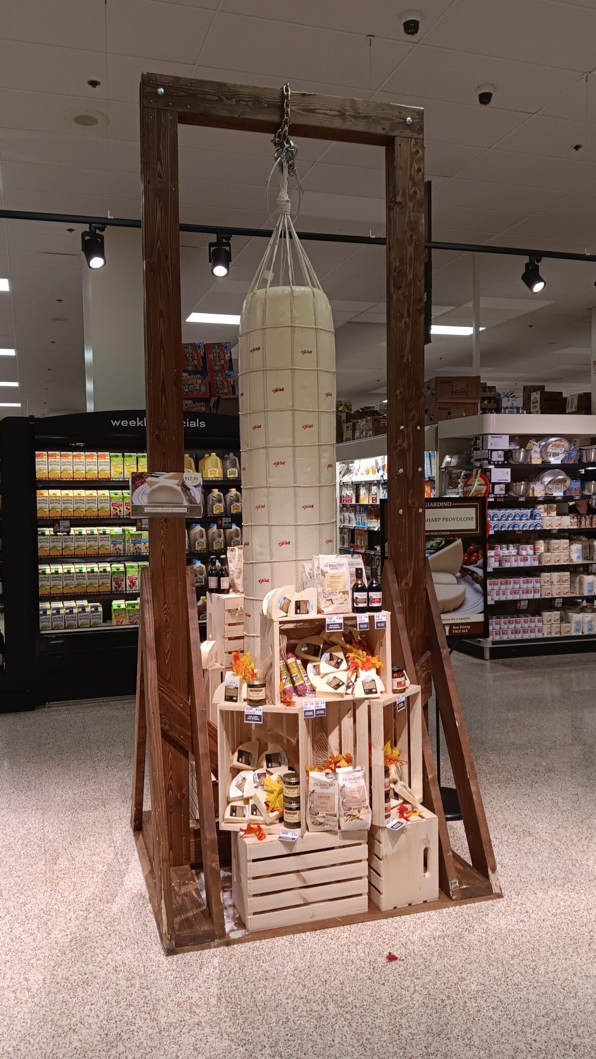 There's a massive log of cheese hanging from a gallows in my local grocery store: