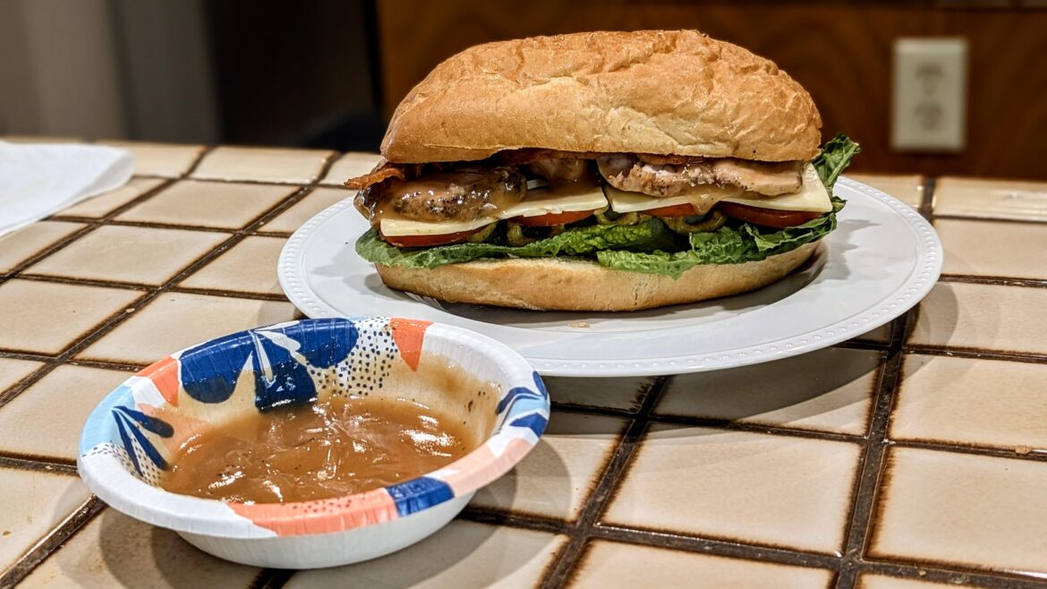 Smoked turkey sandwich with homemade gravy for dipping