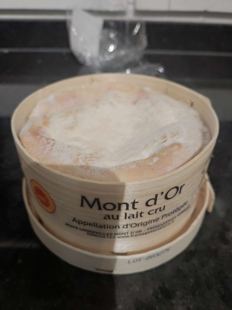 Mont d'Or cheese, that is in an encircled wooden box, that you have to put inside oven then eating it molten and hot with potatoes/sausages/bread/anything
