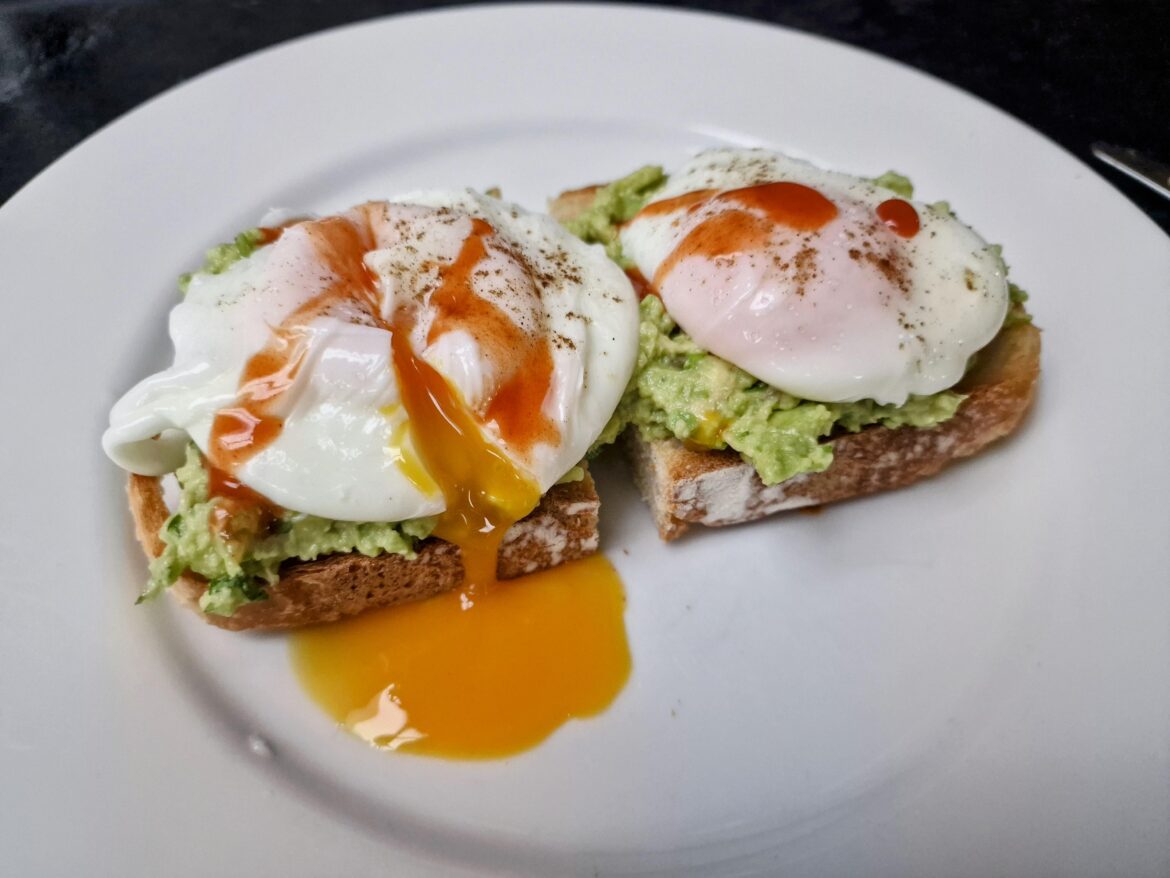 Poached eggs and guacamole on homemade sourdough