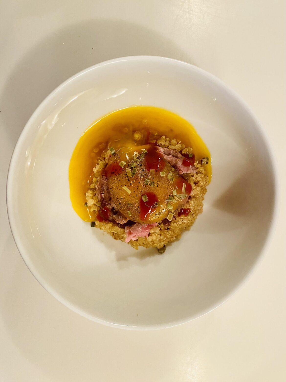 Marinaded Yolk. Shredded Beef. Bone Broth Pepper Quinoa. Chili. Dried Chive.
