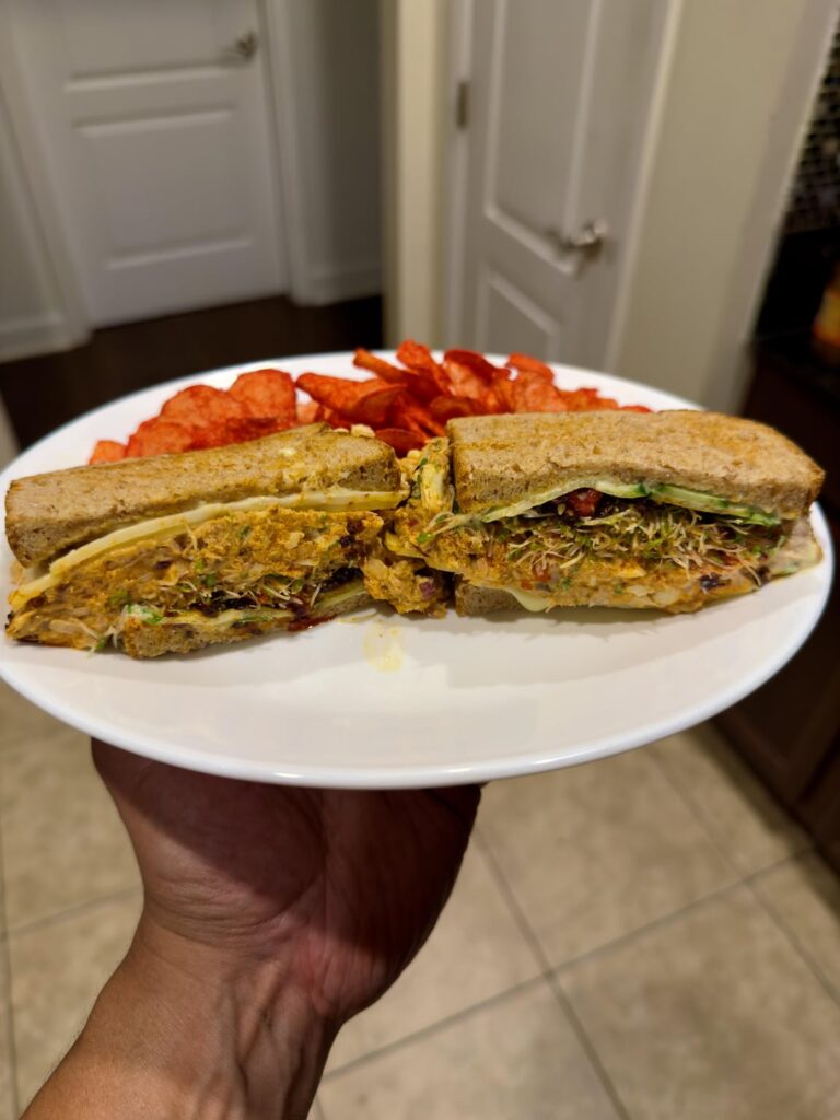 Chili crunch sriracha mayo tuna salad on toasted whole wheat with Carolina Reaper jack cheese, alfalfa sprouts, cucumber and flaming hot kettle cooked chips.