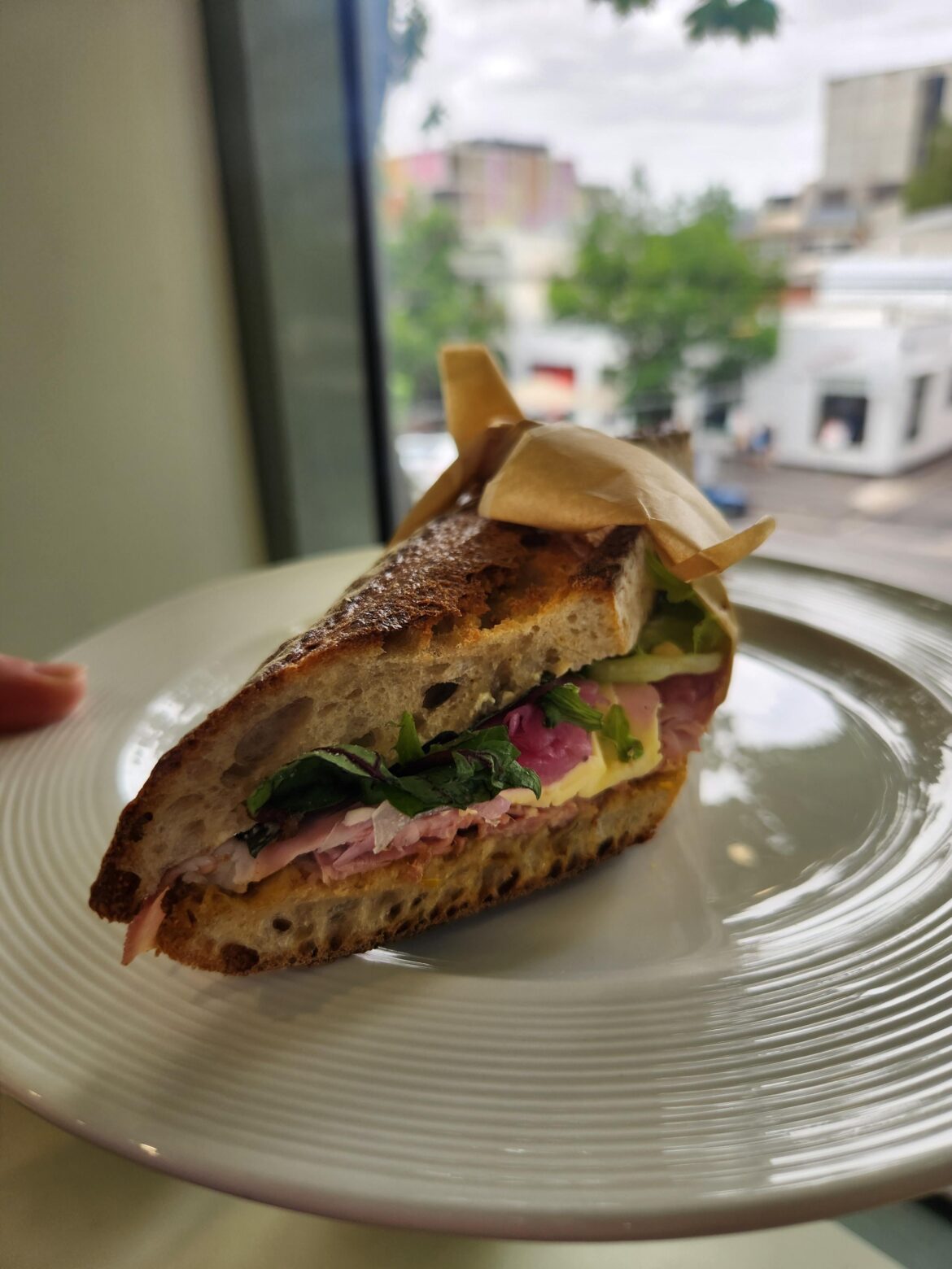 Ham, some type of Swiss cheese, rocket house relish, picked onion on a crunchy baguette 👩🏻‍🍳😙👌🏻