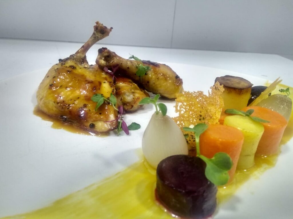 Roasted chicken with orange glaze with a side of butter glazed root vegetables and fondant potatoes.