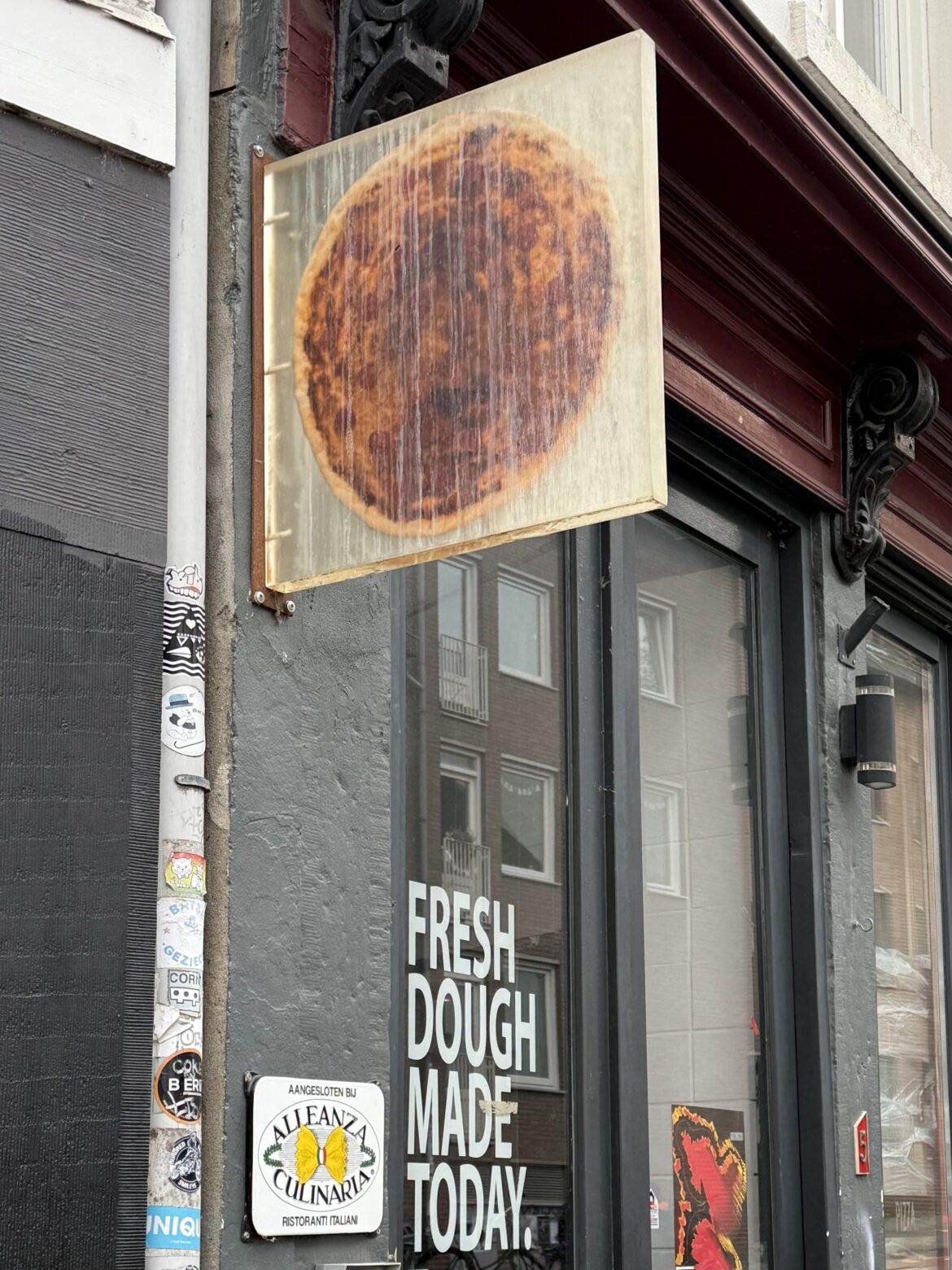 This pizzeria sign is an actual pizza encased in acrylic.